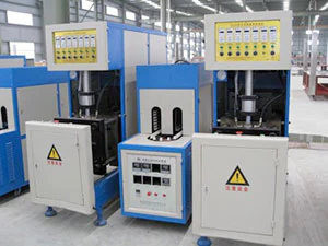 Blue and white bottle blow molding machines in the workshop