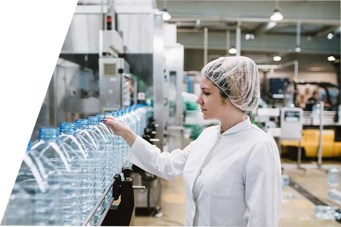 Operator inspecting bottled water on the line