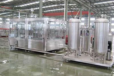 Stainless steel processing tanks and filling equipment in a workshop