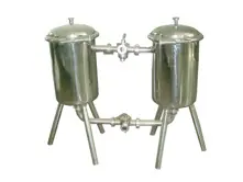 Two stainless steel filtration vessels connected by pipes