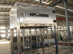 Front view of an enclosed stainless steel filling machine
