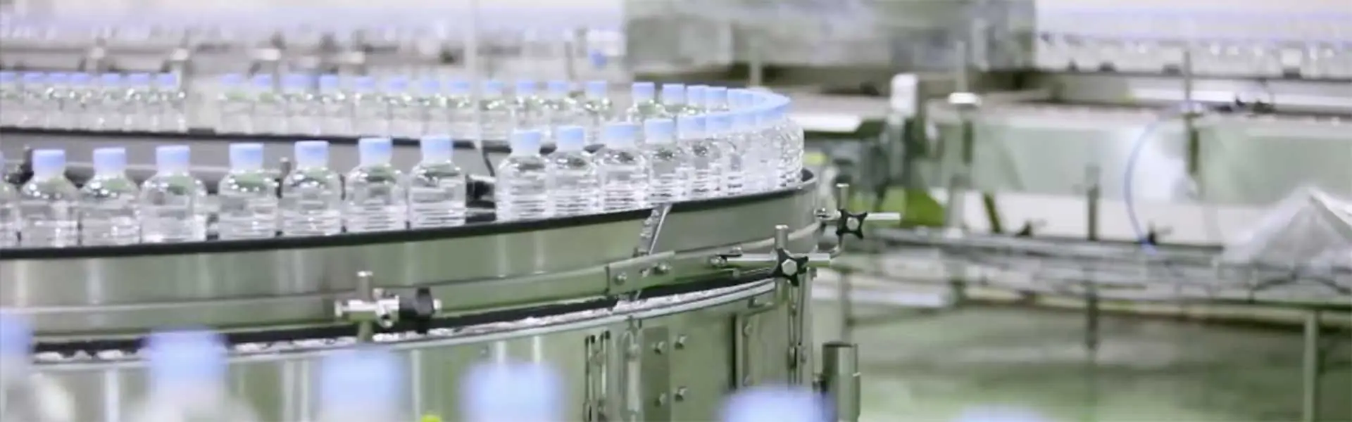 Rows of PET bottles moving along a production conveyor