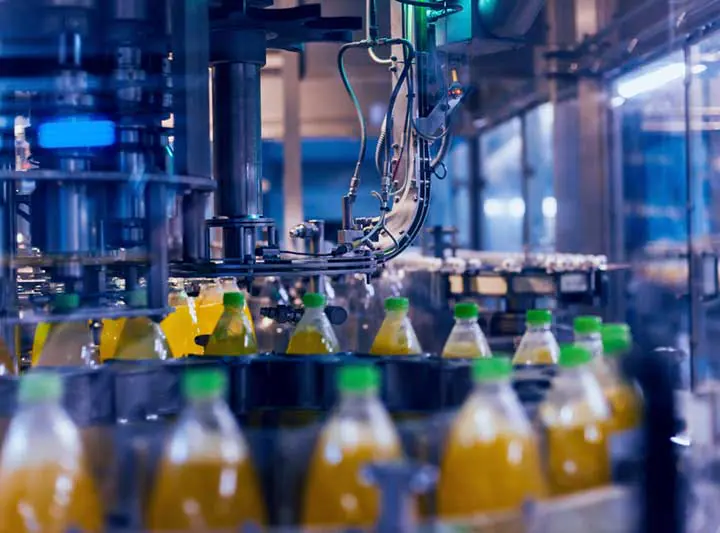 Juice bottles under filling heads
