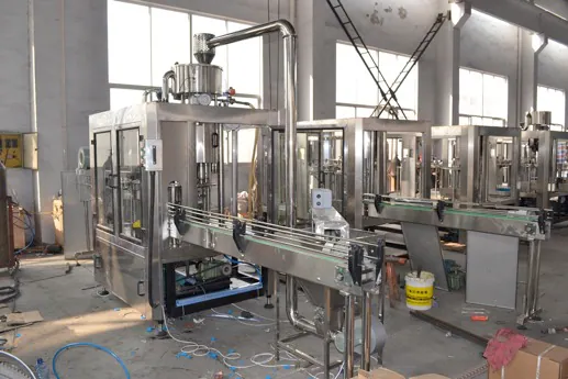 Juice filling machine with cap elevator and conveyors in the workshop