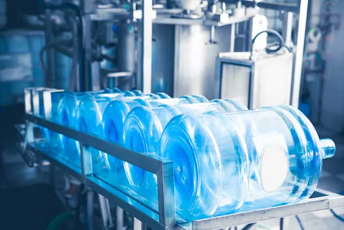 Large water containers on a filling line