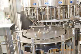 Cooking oil filling turret with stainless steel bottle guides