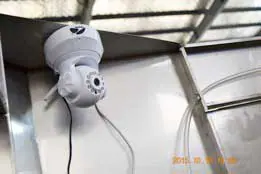 Electric motor mounted beside stainless steel filling equipment