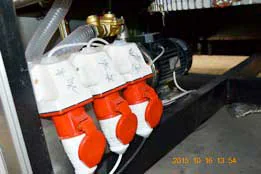 Pneumatic valve assembly with red housings and connecting hoses