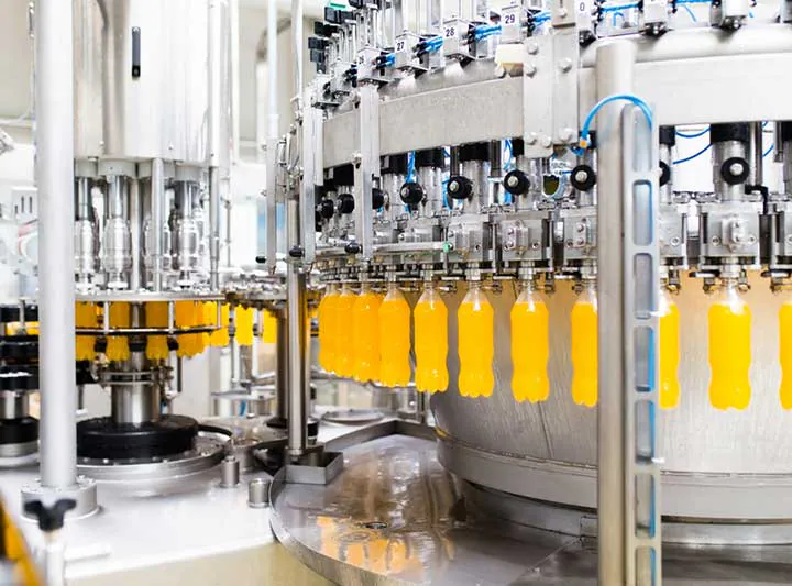 Orange juice bottles under filling valves