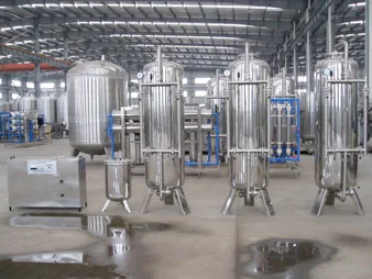 Stainless steel filtration vessels inside a workshop