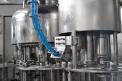 Close view of a three in one filling machine turret